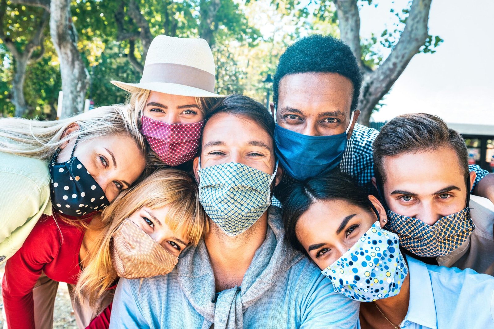 Young black and caucasian woman having good time, drinking fresh