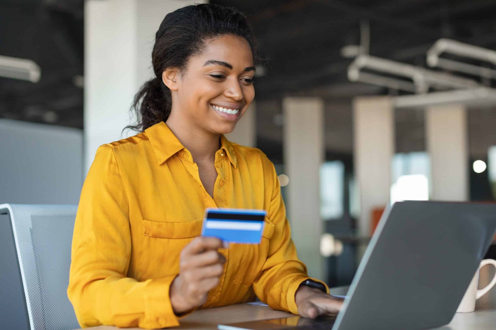 Young black and caucasian woman having good time, drinking fresh